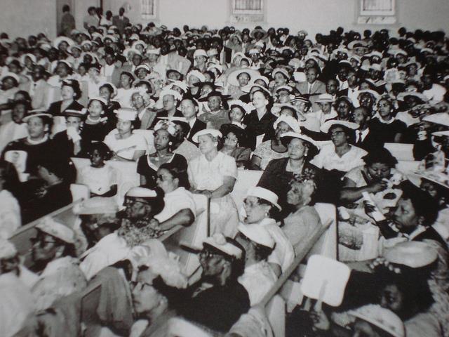 Congregants sit inside church